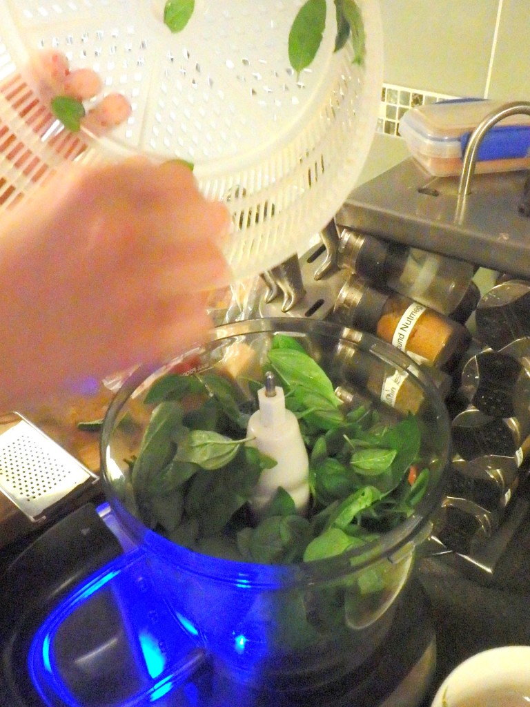 Adding basil leaves to food processor