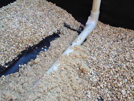 Sand to stop watering tube from moving